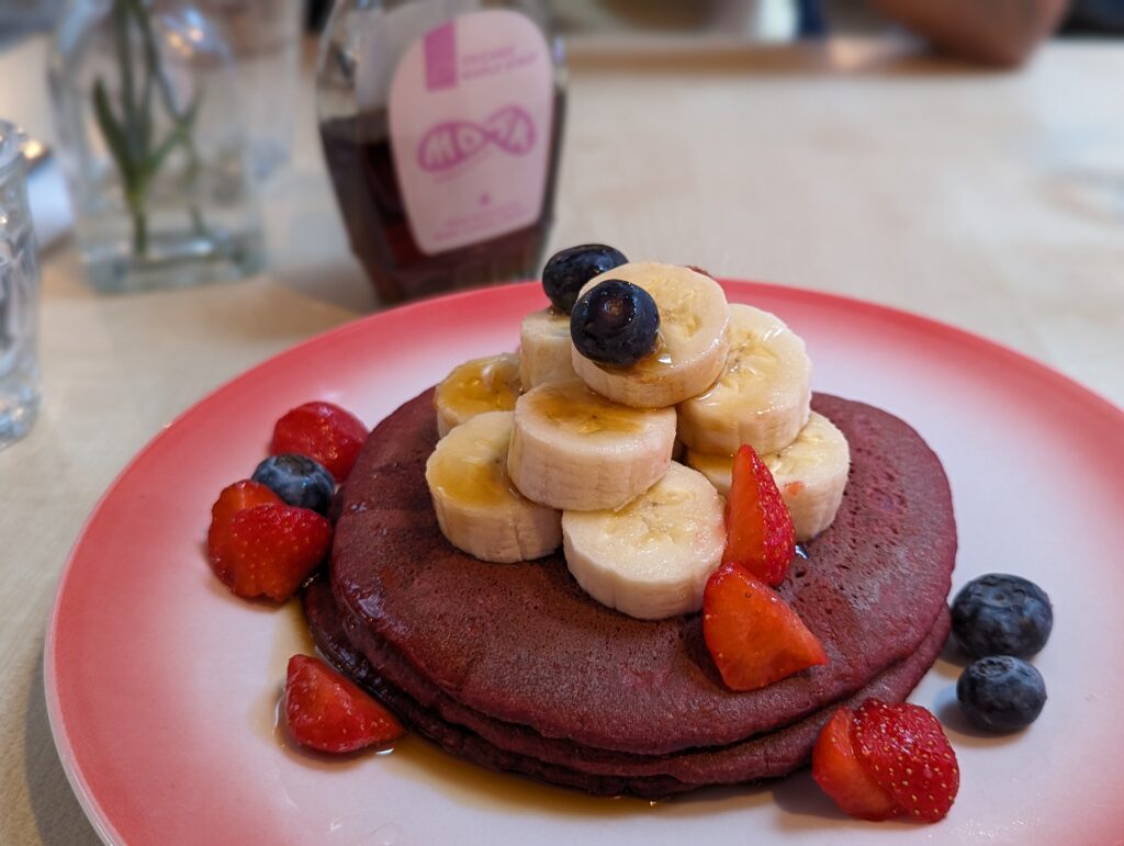 MOAK pancakes, blueberry vegan edition (pink with berries and sliced banana on top)
